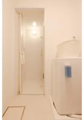 a white bathroom with a shower and a toilet at Lido Alba in Tokyo