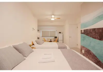 a bedroom with two beds and a chalkboard on the wall at Lido Blu in Tokyo