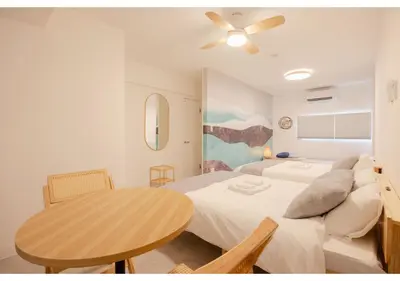 a bedroom with a bed and a table in it at Lido Blu in Tokyo