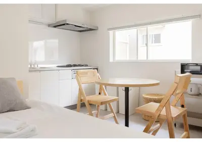 a kitchen with a table and chairs in a room at Lido Blu in Tokyo