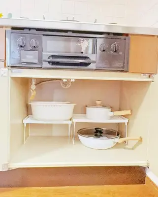 a kitchen with a microwave and bowls on a shelf at Oshiage Sta U-Court Kinshicho in Tokyo