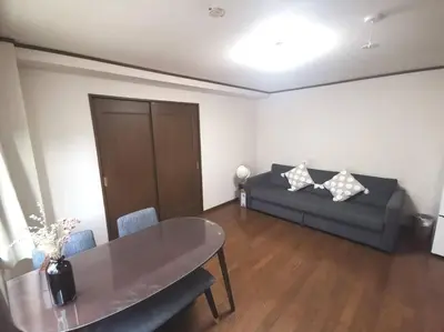 a living room with a couch and a table at Oshiage Sta U-Court Kinshicho in Tokyo