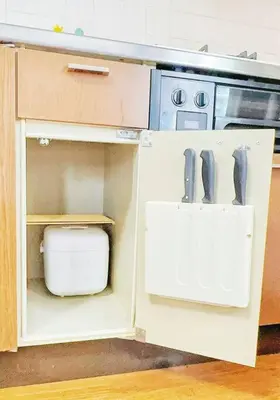 a kitchen with an open cabinet with a stove at Oshiage Sta U-Court Kinshicho in Tokyo