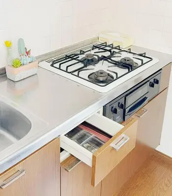 a kitchen with a stove top in a kitchen at Oshiage Sta U-Court Kinshicho in Tokyo