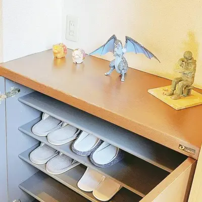 a shelf with shoes and figurines on a dresser at U-Court Kinshicho 3F in Tokyo