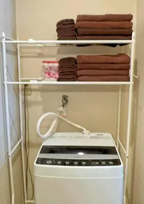 a white stove in a kitchen with towels at U-Court Kinshicho 3F in Tokyo