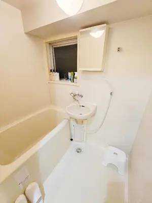 a white bathroom with a sink and a bath tub at ueno minowa 602 in Tokyo