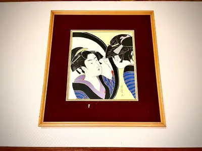 a framed picture of two women on a wall at \u5e1d\u4eac\u5927\u5b66\u4ed8\u8fd1 \u5341\u6761 in Tokyo