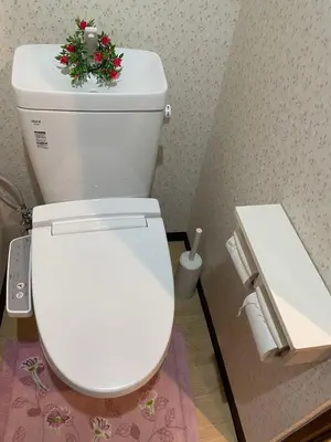 a white toilet with a christmas ornament on top of it at \u5e1d\u4eac\u5927\u5b66\u4ed8\u8fd1 \u5341\u6761 in Tokyo