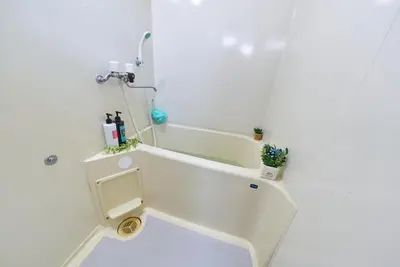 a white bathroom with a shower and a toilet at Belmont 101 3min to Station Easy Access Ueno Asakusa Skytree Sleeps 5 in Tokyo