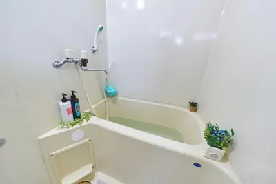 a white bathroom with a toilet and a bath tub at Belmont 101 3min to Station Easy Access Ueno Asakusa Skytree Sleeps 5 in Tokyo