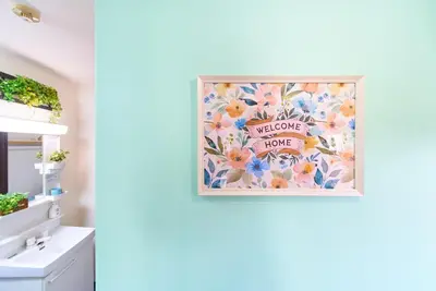 a bathroom with a picture of flowers on the wall at Belmont 101 3min to Station Easy Access Ueno Asakusa Skytree Sleeps 5 in Tokyo