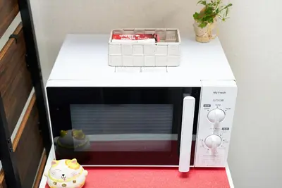 a microwave sitting on top of a red table at Belmont 101 3min to Station Easy Access Ueno Asakusa Skytree Sleeps 5 in Tokyo