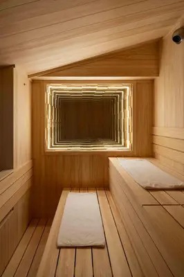 a sauna with a window and two beds in it at KUTSUROGI SAUNA and STAY in Tokyo