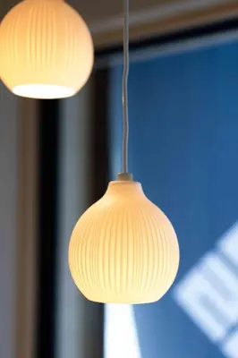 a pair of lights hanging from a ceiling at KUTSUROGI SAUNA and STAY in Tokyo