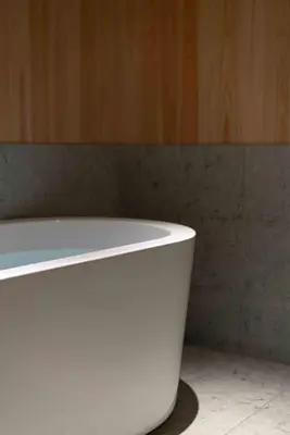 a white bath tub sitting in a bathroom at KUTSUROGI SAUNA and STAY in Tokyo