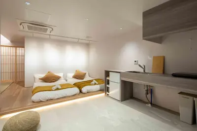 a bedroom with a bed and a sink in it at KUTSUROGI SAUNA and STAY in Tokyo