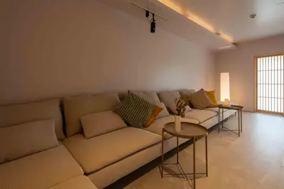 a living room with a couch and two tables at KUTSUROGI SAUNA and STAY in Tokyo