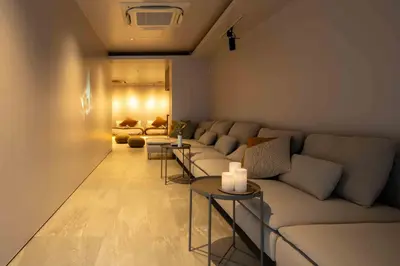 a living room with a couch and a table at KUTSUROGI SAUNA and STAY in Tokyo