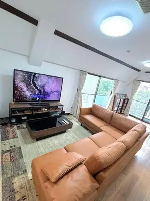 a living room with a couch and a flat screen tv at \u6c60\u888b\u99c5\u307e\u3067\u96fb\u8eca\u30677\u5206 4LDK98m2 in Tokyo
