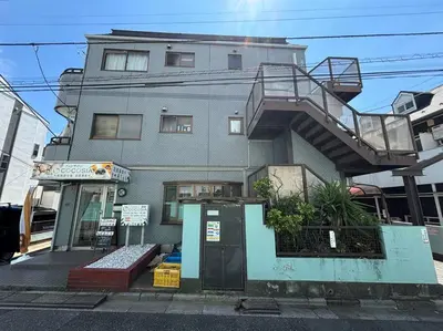 a building with a staircase on the side of it at \u6c60\u888b\u99c5\u307e\u3067\u96fb\u8eca\u30677\u5206 4LDK98m2 in Tokyo