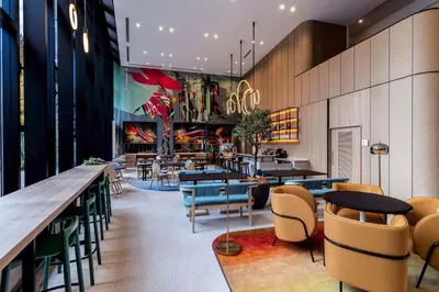 a restaurant with tables and chairs and a bar at YOTEL Tokyo Ginza in Tokyo