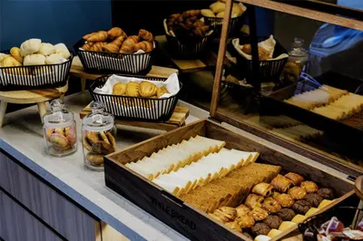 a buffet with various types of bread and pastries at YOTEL Tokyo Ginza in Tokyo