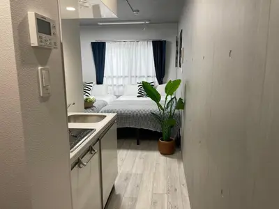 a kitchen with a sink and a bed in a room at COMMA HOUSE Otsuka 201 in Tokyo