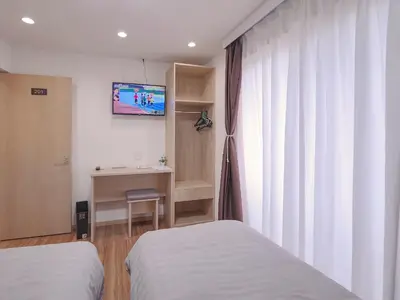 a room with two beds and a desk and a television at City Pal Sakurashinmachi - Vacation STAY 17738 in Tokyo
