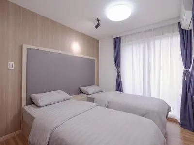 a hotel room with two beds and a window at City Pal Sakurashinmachi - Vacation STAY 17738 in Tokyo