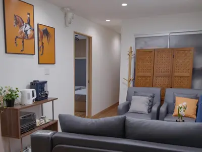 a living room with a couch and a horse picture on the wall at City Pal Sakurashinmachi - Vacation STAY 17738 in Tokyo