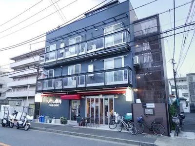 a building with bikes parked in front of it at City Pal Sakurashinmachi - Vacation STAY 17738 in Tokyo