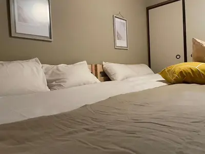 two beds in a room with white sheets and pillows at \u30b5\u30cb\u30fc\u30cf\u30a4\u30c4 in Tokyo