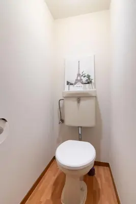 a bathroom with a toilet with a picture of the eiffel tower at \u30b5\u30cb\u30fc\u30cf\u30a4\u30c4 in Tokyo