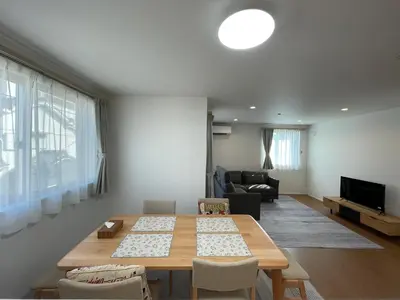 a living room with a wooden table and a couch at Starry Ocean in Tokyo