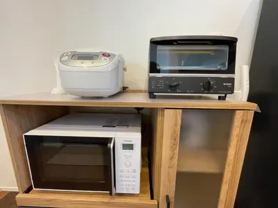 a microwave and a toaster oven and a printer on a shelf at Starry Ocean in Tokyo