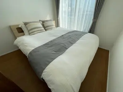 a large bed in a bedroom with a window at Starry Ocean in Tokyo