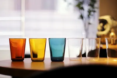 a group of different colored glasses sitting on a table at Streamer \u685c\u4e18\u753a House Shibuya station in Tokyo