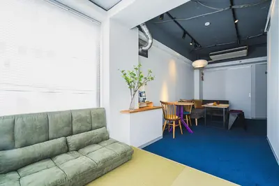 a living room with a couch and a table at Streamer \u685c\u4e18\u753a House Shibuya station in Tokyo