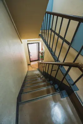 a staircase in a building with a metal railing at Streamer \u685c\u4e18\u753a House Shibuya station in Tokyo