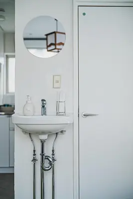 a bathroom with a sink and a mirror at Streamer \u685c\u4e18\u753a House Shibuya station in Tokyo
