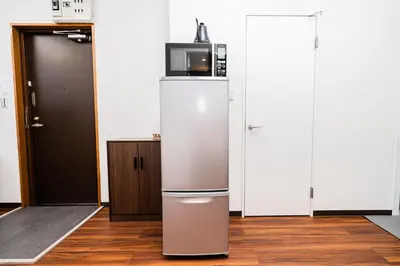 a refrigerator with a microwave on top of it at Momostay Skytree\u524d\u4f11\u696d\u4e2d in Tokyo