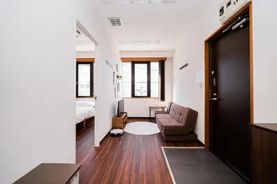 a living room with a couch and a bed at Momostay Skytree\u524d\u4f11\u696d\u4e2d in Tokyo