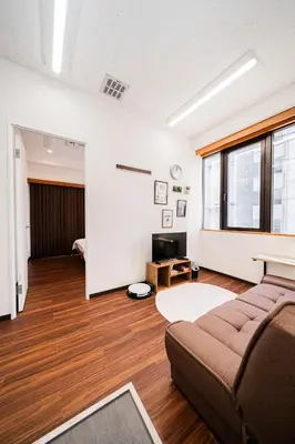 a living room with a couch and a table at Momostay Skytree\u524d\u4f11\u696d\u4e2d in Tokyo