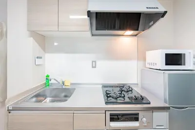 a kitchen with a sink and a microwave at \u6d45\u8349\u30a2\u30d1\u30fc\u30c8\u30e1\u30f3\u30c8301 in Tokyo