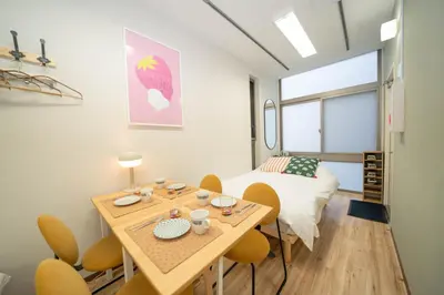 a room with a table and chairs and a bed at \u677e\u304c\u8c37\u30a2\u30d1\u30fc\u30c8\u30e1\u30f3\u30c8201 in Tokyo