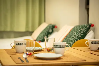 a wooden table with cups and plates on it at \u677e\u304c\u8c37\u30a2\u30d1\u30fc\u30c8\u30e1\u30f3\u30c8201 in Tokyo