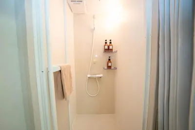 a bathroom with a shower with a shower curtain at \u677e\u304c\u8c37\u30a2\u30d1\u30fc\u30c8\u30e1\u30f3\u30c8201 in Tokyo