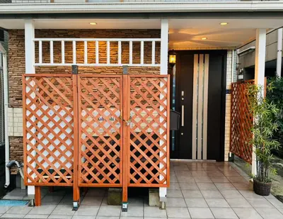 a front door of a house with a wooden gate at KOBAYASHi \u6771\u4eac in Tokyo