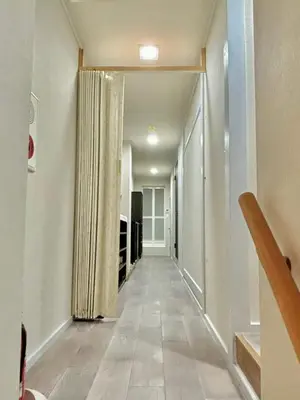 an empty hallway with a hallway leading to a room at KOBAYASHi \u6771\u4eac in Tokyo